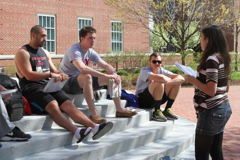 a group of men sitting on steps outside