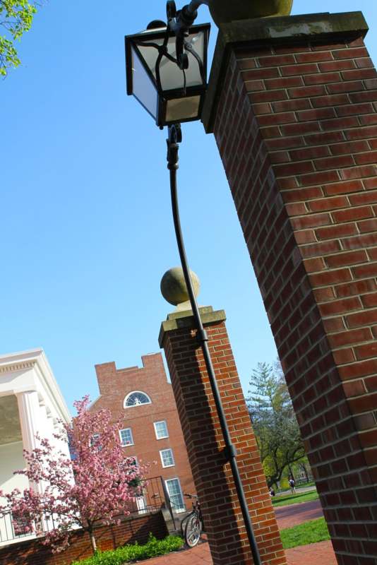 a lamp post on a brick pillar