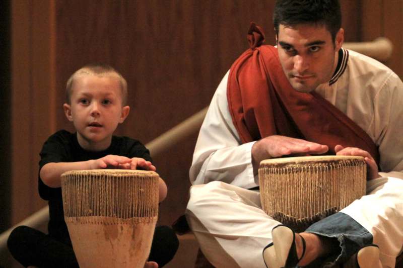 a man and boy playing drums