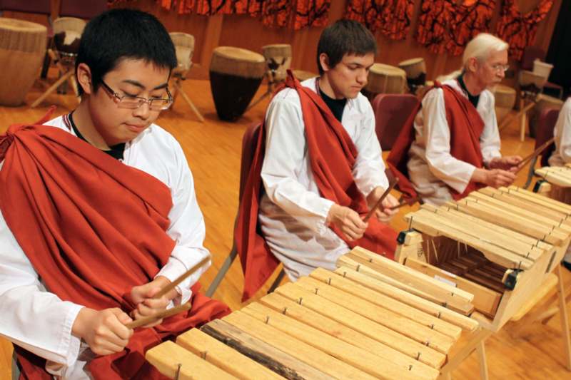 a group of people playing xylophones