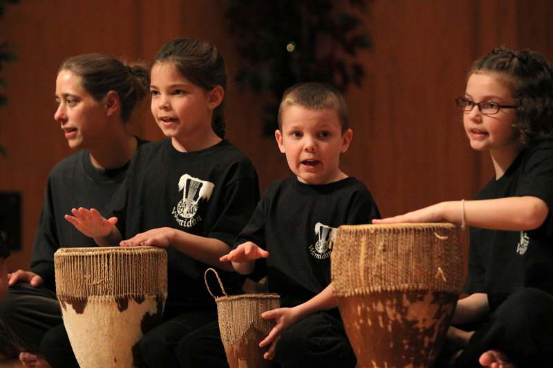 a group of children playing drums