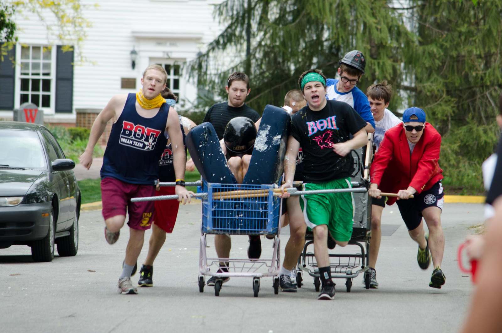 a group of people pushing a cart with a person in it