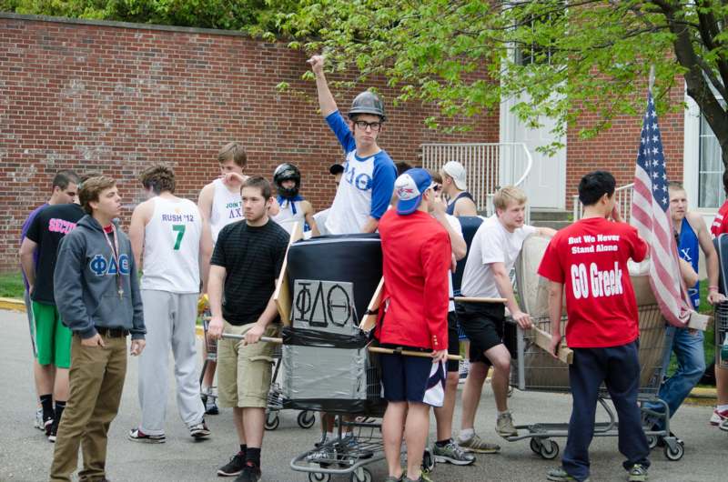 a group of people standing around a cart