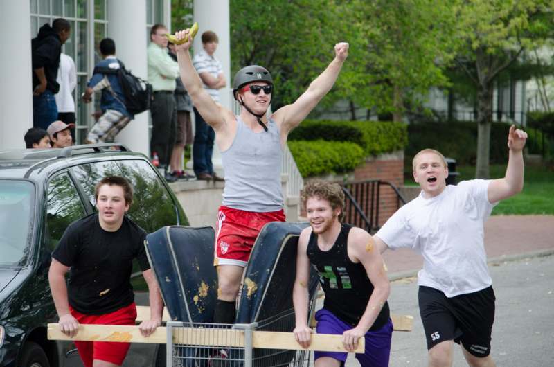 a group of men riding on a cart