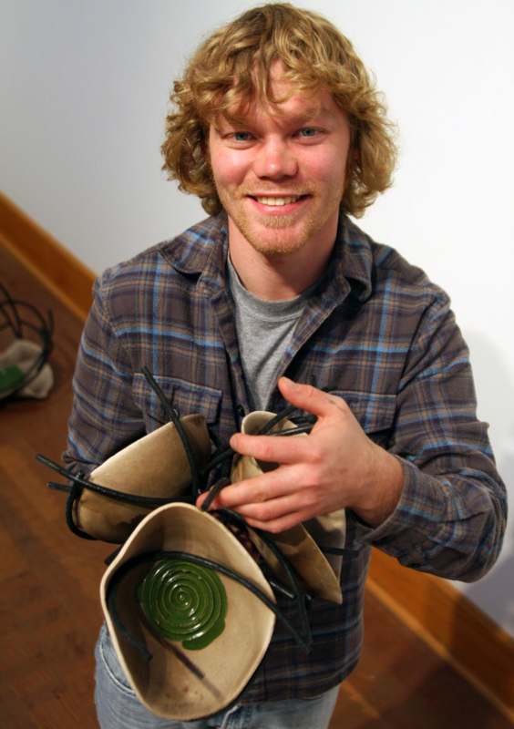 a man holding a pair of shoes