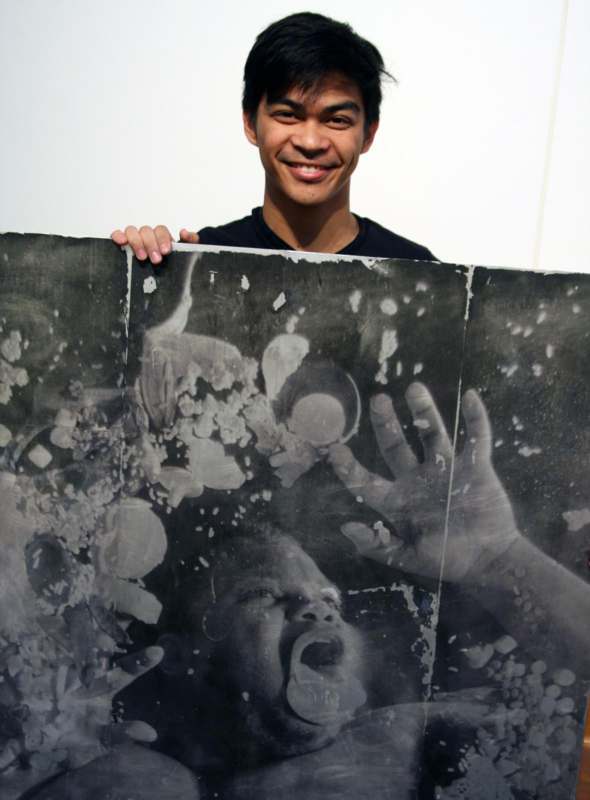 a man holding a large black and white photo