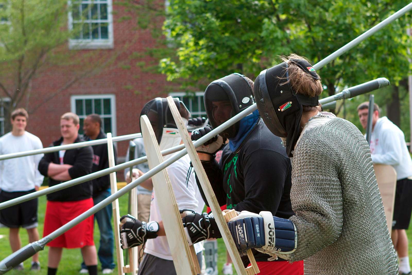 a group of people wearing fencing gear