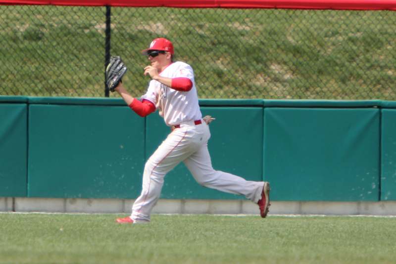 a baseball player running to catch a ball