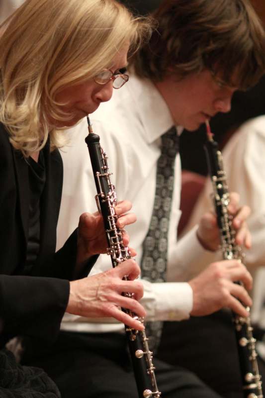 a man and woman playing clarinets