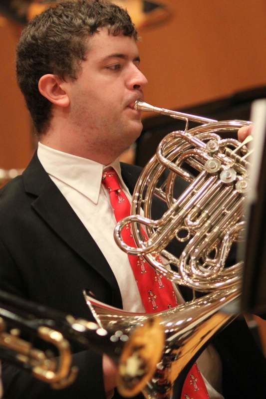 a man playing a french horn