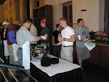 a group of people standing around a table