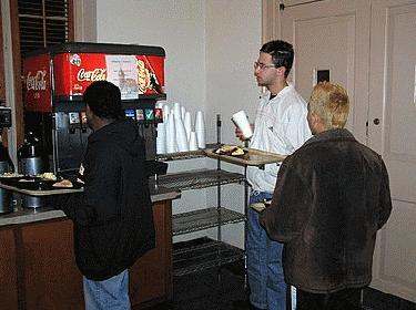 a group of people standing in a cafeteria