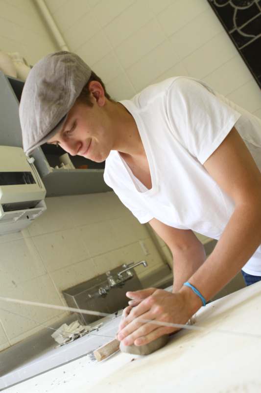 a man in a cap working on a sink