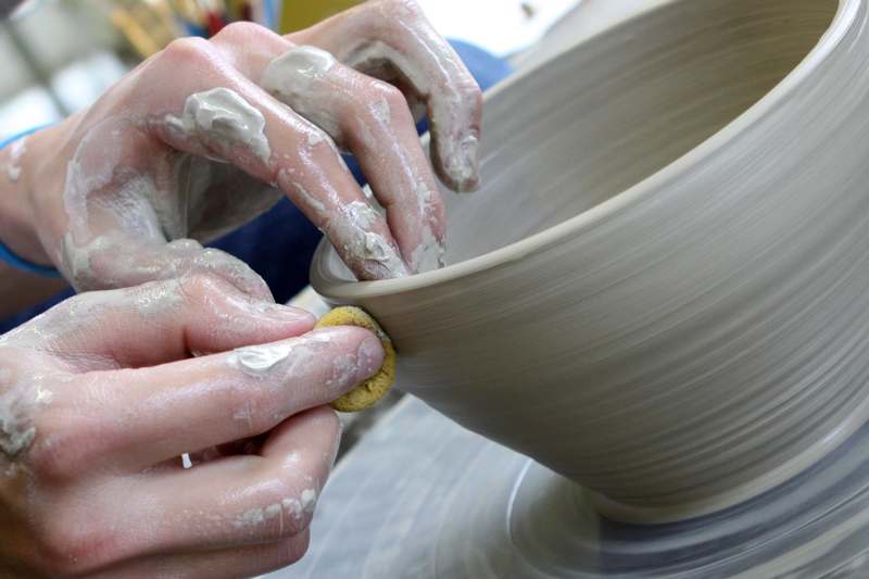 a person's hands making a bowl