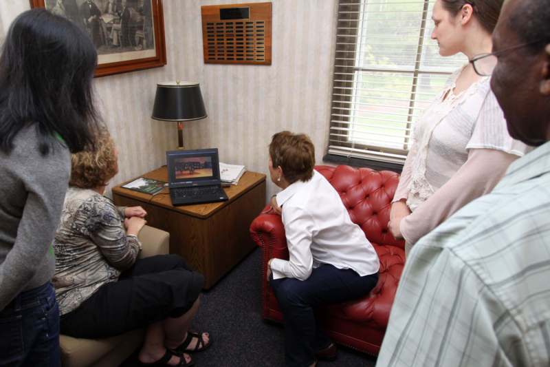 a group of women looking at a laptop