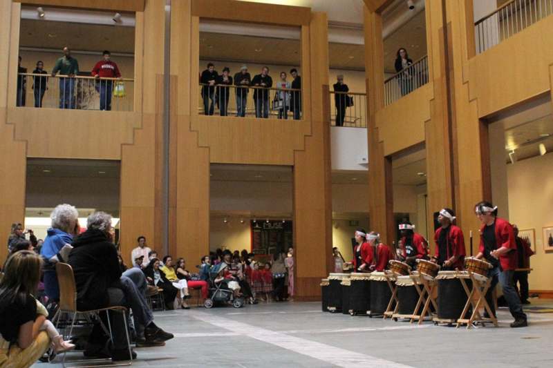 a group of people playing drums in a building