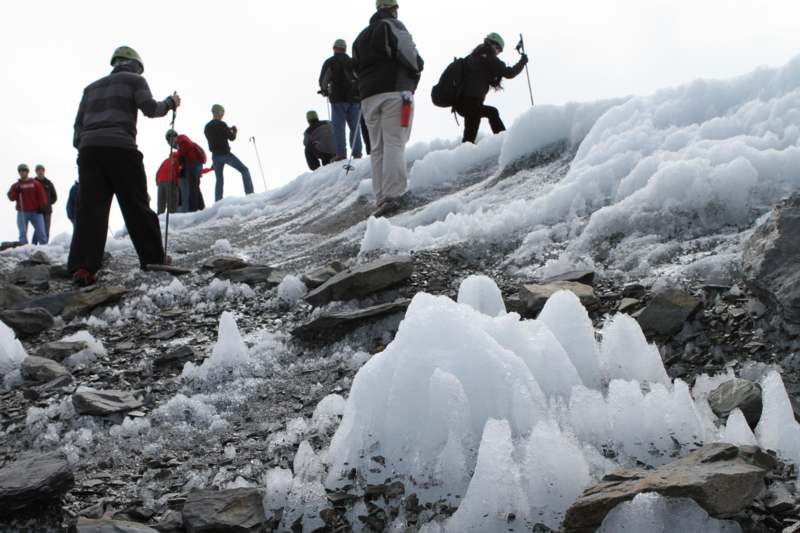 a group of people climbing a snowy mountain