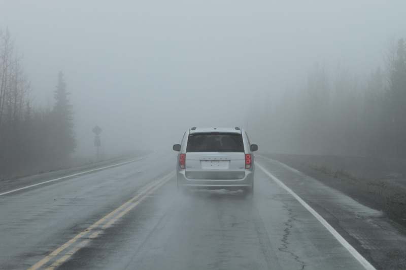 a car driving on a foggy road