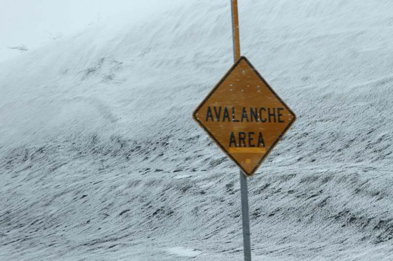 a sign on a snowy road