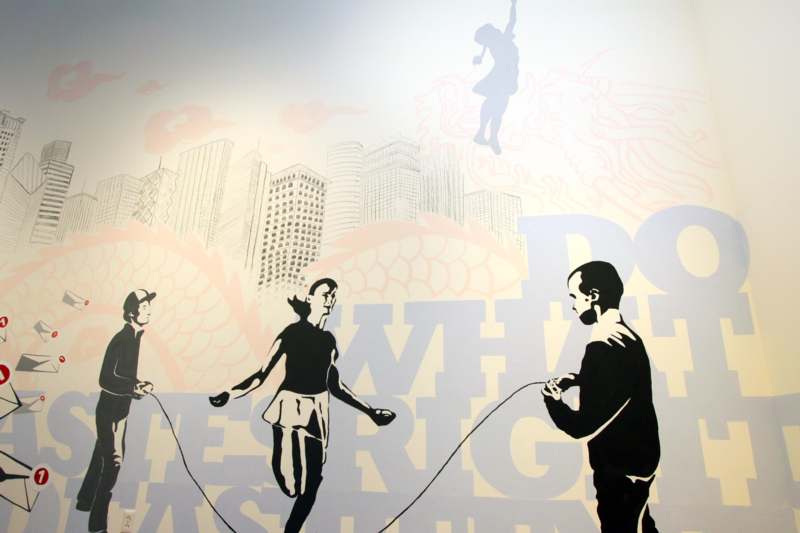 a mural of a man and a woman playing with a rope