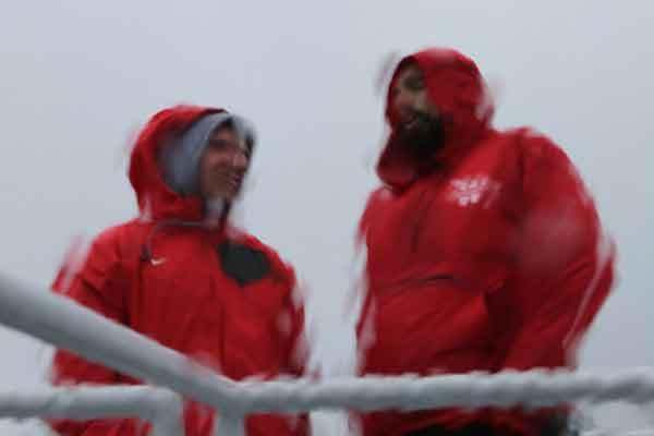a couple of men wearing red jackets
