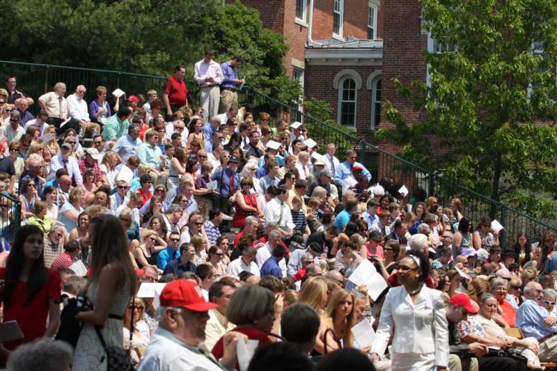 a large crowd of people sitting on stairs