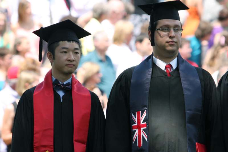 a couple of men wearing graduation caps and gowns