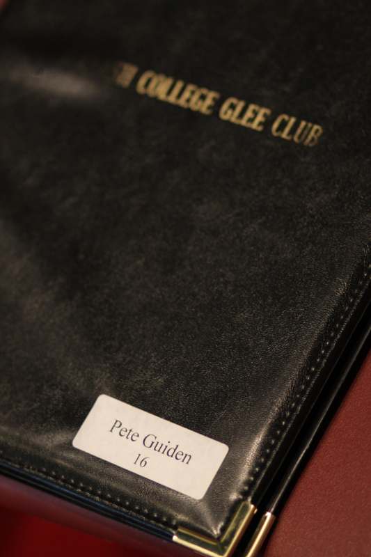 a black leather folder with a name tag