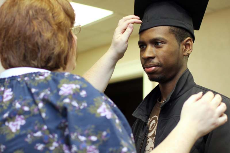 a person putting on a graduation cap