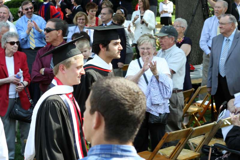 a group of people standing in front of a graduation ceremony