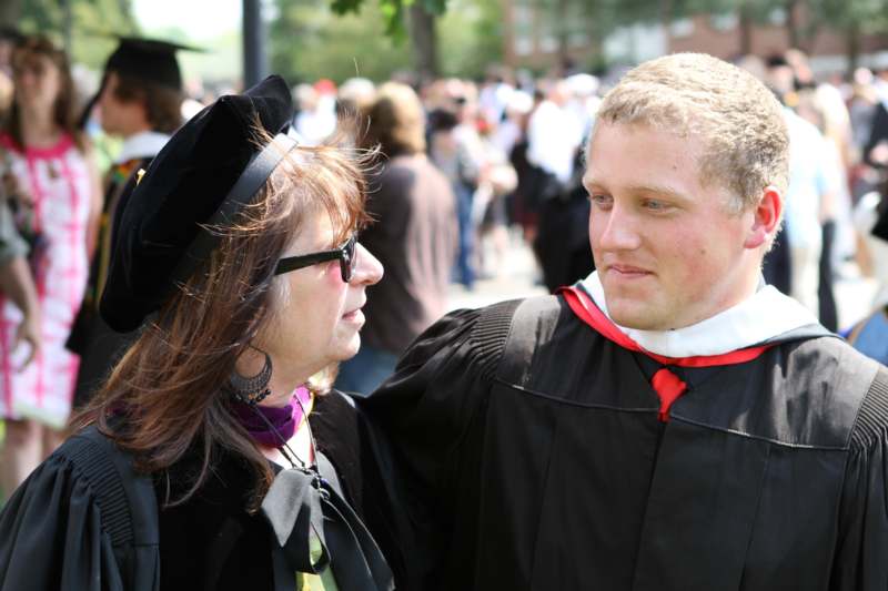 a man and woman in graduation gowns