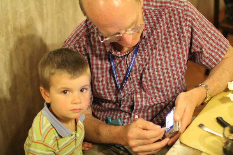 a man and child looking at a cell phone