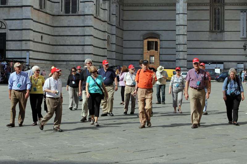 a group of people walking in a courtyard