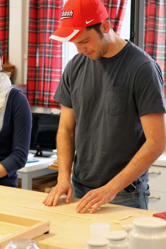 a man cutting a piece of wood