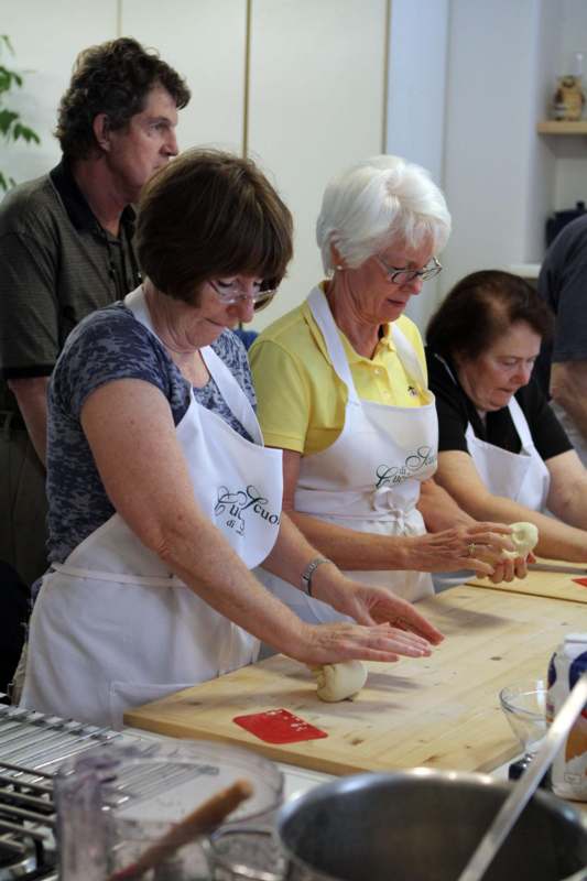 a group of women making dough