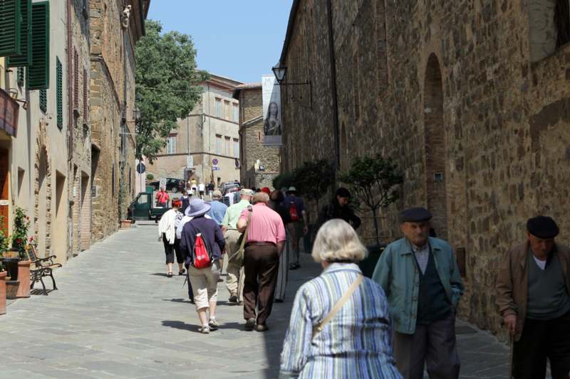 a group of people walking down a narrow street
