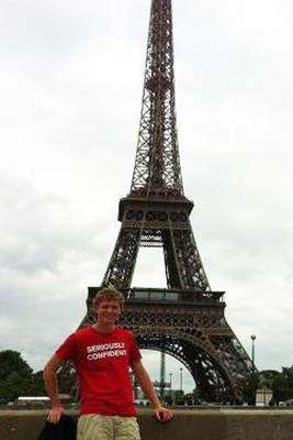 a man standing in front of Eiffel Tower