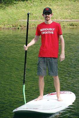 a man standing on a paddle board