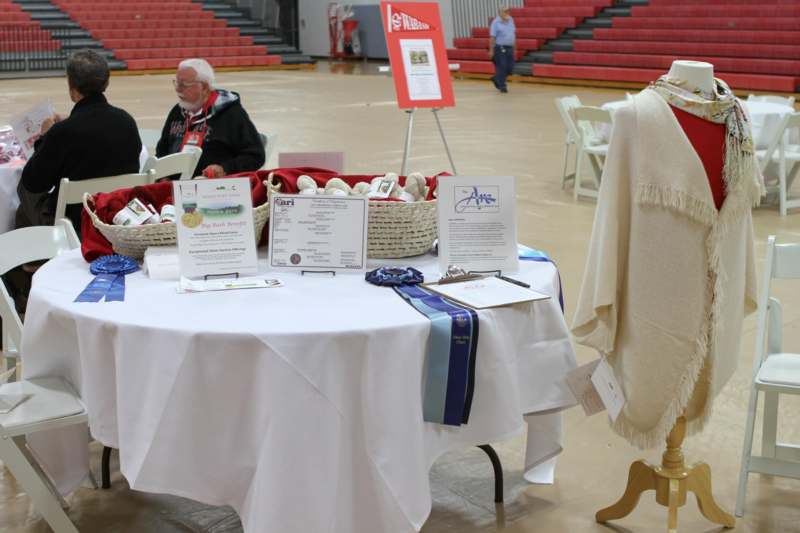a table with a white tablecloth and a white tablecloth with blue ribbons and a white blanket