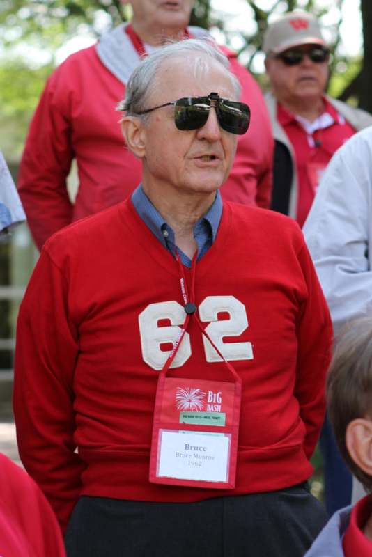 a man wearing sunglasses and a red sweater