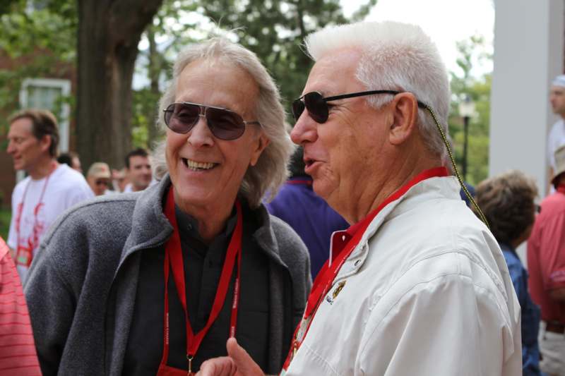two men wearing sunglasses and lanyards