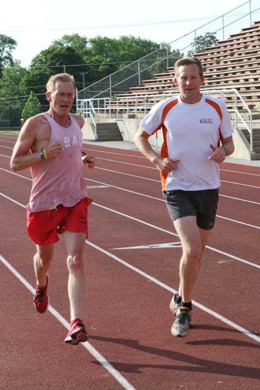 two men running on a track