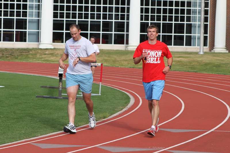 a couple of men running on a track
