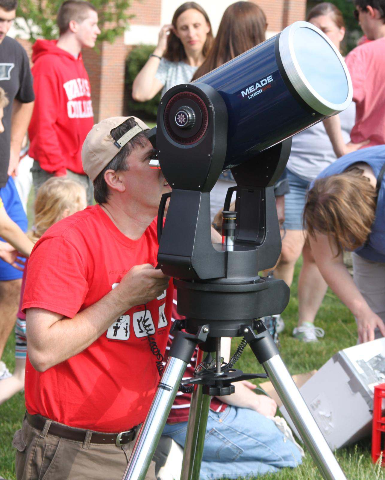 a man looking through a telescope