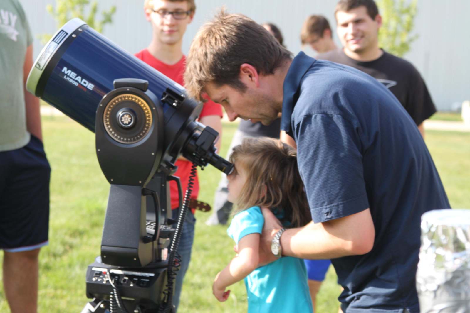 a man looking through a telescope