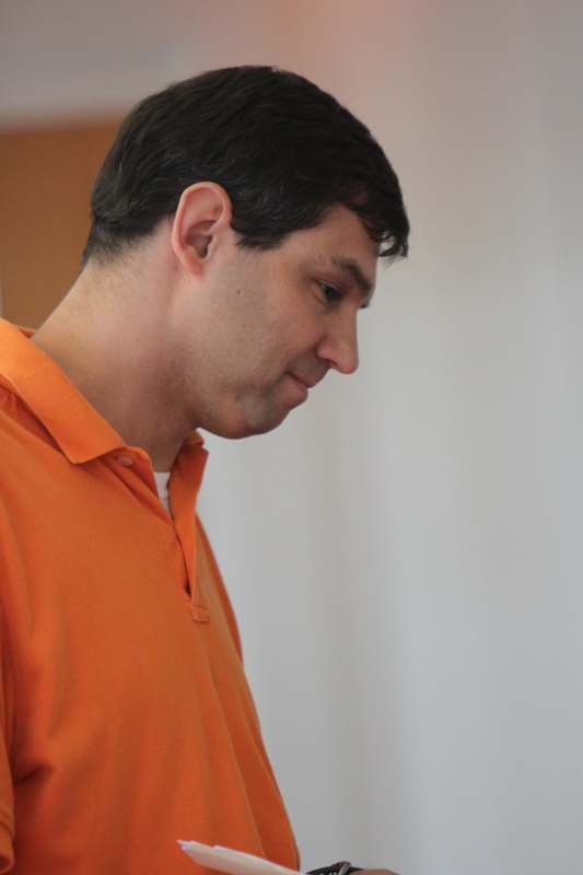 a man in an orange polo shirt