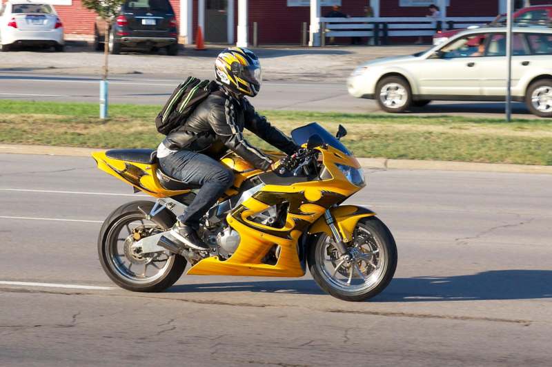 a person riding a yellow motorcycle