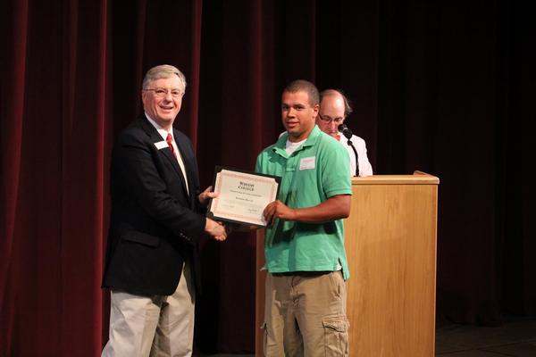 a man receiving a certificate from a man
