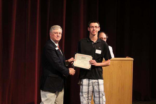 a man holding a certificate