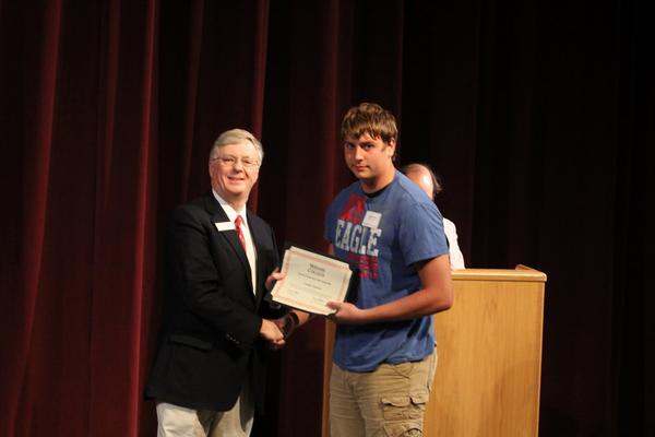 a man holding a certificate
